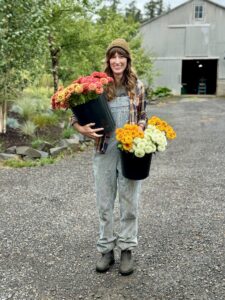 Lindsay - Fawn Lily Farm holding buckets of fresh picked flowers.